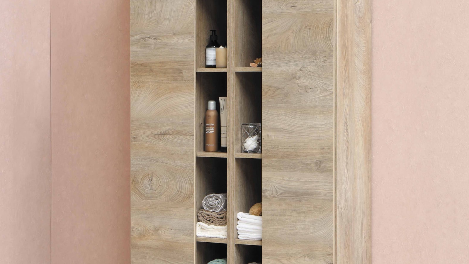 Oak bathroom shelving with neatly folded towels and toiletries