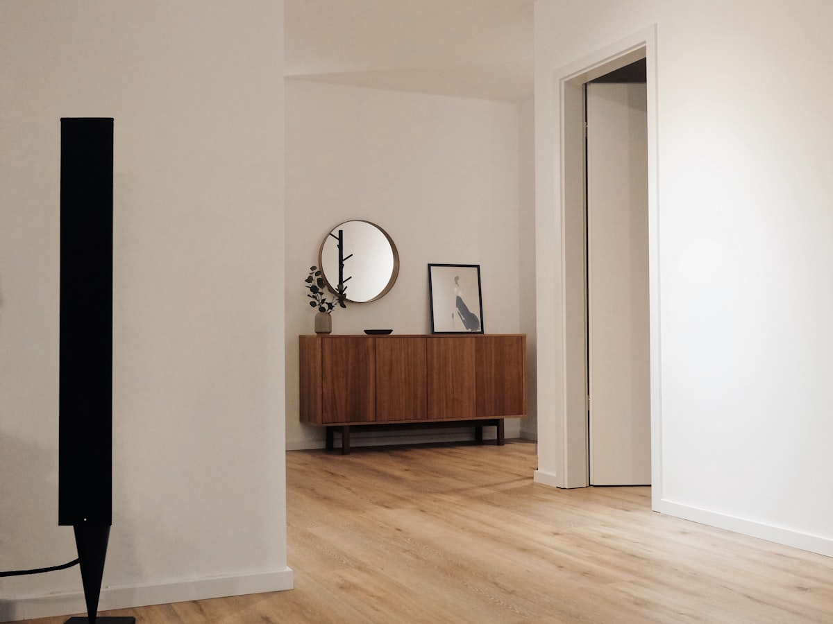 A clean finished interior with wood flooring, trim, and a doorway